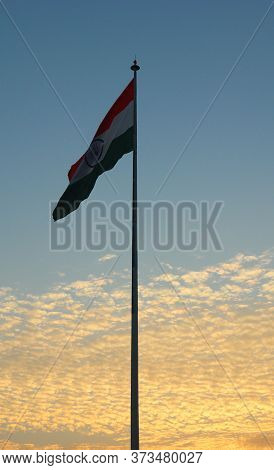 India Flag With Coludy Sky In The Background