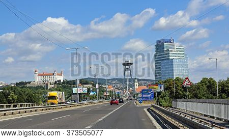 Bratislava, Slovakia - July 10, 2015: Castle And Snp Bridge With Restaurant On Top Of Pylon In Brati