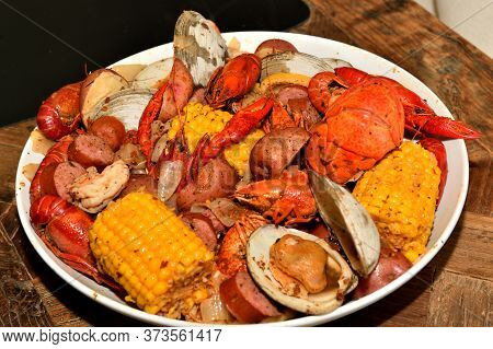 Cajun style seafood boil. Lobster, crawfish, shrimp, clams, potatoes, corn, and kielbasa sausages.