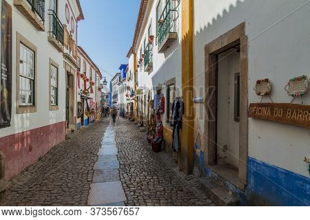Obidos, Portugal - October 12, 2017: Tourists In A Narrow Street In Obidos Village, Portugal