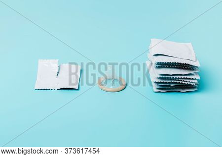 Condom On A Blue Background. The Concept Of Safe Sex, Stopping The Transmission Of Sexually Transmit
