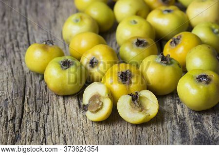 Fresh Ripe Yellow Hawthorn Fruits In Bowl On Wooden Rustic Background. Crataegus Monogyna Berries, H