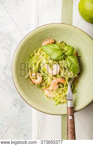 Zucchini Vegetable Noodles - Green Zoodles Or Courgette Spaghetti  With Shrimps On Plate Over Gray B