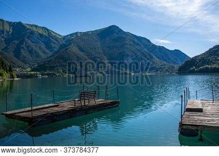Beautiful View Of Lake Ledro With Pontoon Boats, Villages And The Daily Life Of A Mountain Lake In T