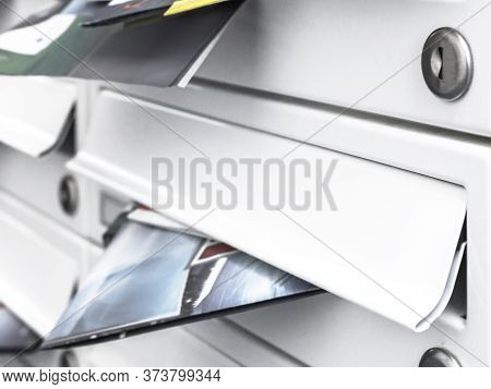 Business And Advertising Concepts. Modern Mailboxes Filled Of Flyers. Close-up. Shallow Dof.