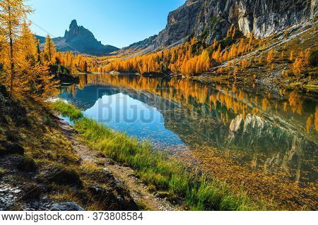 Beautiful Autumn Landscape With Spectacular Mountain Lake And Colorful Yellow Larches In The Dolomit