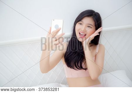 Beautiful Young Asian Woman Sexy In Underwear Talking A Selfie On Smartphone For Social Network In T