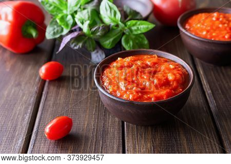 Balkan Sauce Ajvar And Ingredients For Its Preparation On A Wooden Table. Serbian Traditional Food