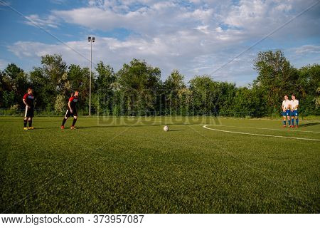 Soccer Player Kicks The Ball.soccer Player Takes The Free-kick.