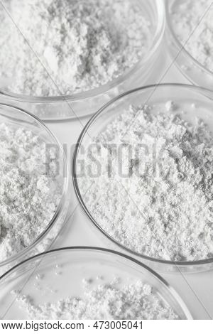 Petri Dishes With Calcium Carbonate Powder On White Table, Closeup
