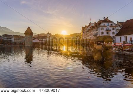Lucerne, Switzerland - February 20, 2023: Sunset View Of The Chapel Bridge, And The Reuss River, Wit