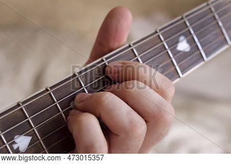 Man Playing Guitar Chord. Unrecognizable Person Rehearsing. Strumming Acoustic Guitar. Musician Play