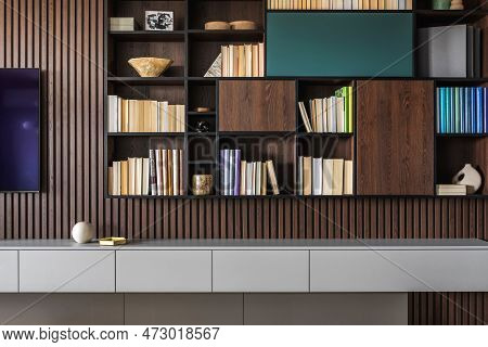 Modern Bookcase In Lamells Wall. Grey Chest Of Drawers. Bookcase A Lot Of Books And Accessories. Her