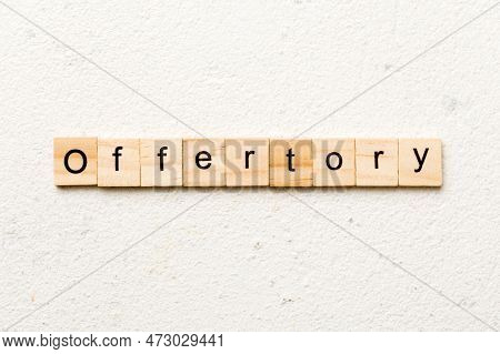 Offertory Word Written On Wood Block. Offertory Text On Table, Concept.