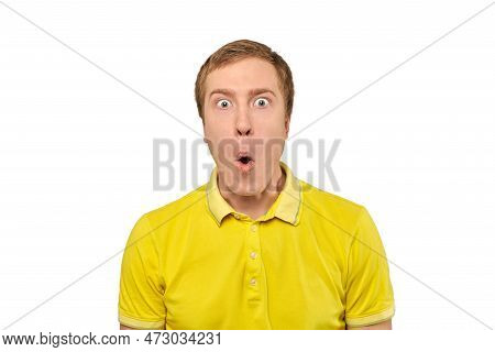 Surprised Young Man With Funny Facial Expression In Yellow T-shirt, White Isolated Background. Shock