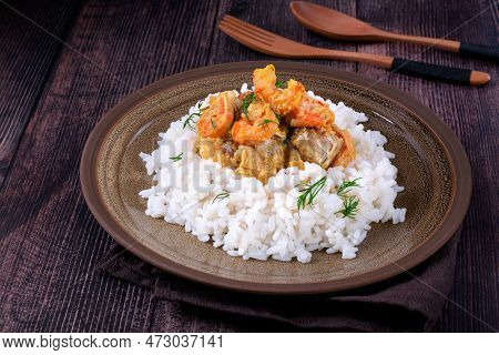 Fish Curry With Codfish, Pollack And Shrimps With Coconut Milk Served On Rice On Brown Plate