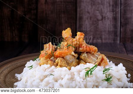 Fish Curry With Codfish, Pollack And Shrimps With Coconut Milk Served On Rice On Brown Plate