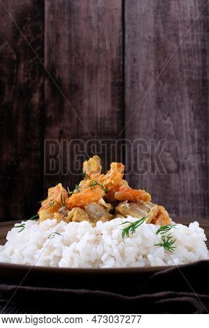 Fish Curry With Codfish, Pollack And Shrimps With Coconut Milk On Rice On Brown Plate