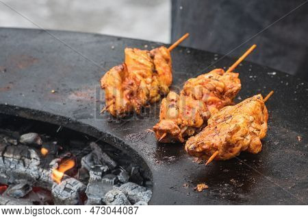 Preparing Chicken Meat Skewers, Grilled Or Roasted In A Barbecue On An Open Fire With Flames, Shashl
