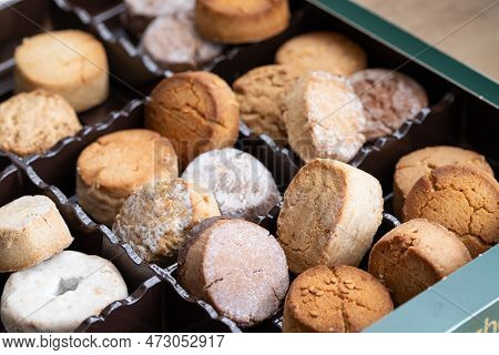 Variety Of Spanish Shortbreads Mantecados, Polvorones, Nevaditos In Black Box. Typical Sweets Consum