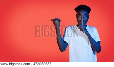 Black Guy Showing Silence Gesure And Pointing At Copy Space