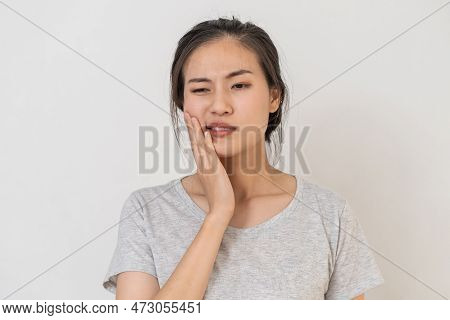 Closing Eyes Asian Young Woman Touching Cheek, Face Expression From Toothache, Tooth Decay Or Sensit