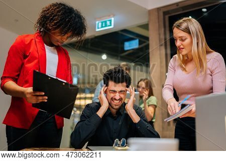 Portrait Of Exhausted Team Leader Under Stress Sitting At Table With Laptop Holding Pain Head. Femal