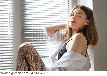 Sensual Aroused Girl In Lingerie Sitting On Window In Sunlight With Blinds