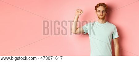 Confident Redhead Man Standing United With Black Lives Matter Movemet, Showing Raised Fist And Looki