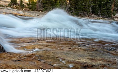 Small Waterwheel Breaks Over The Orange Rocks Below In Yosemite National Park