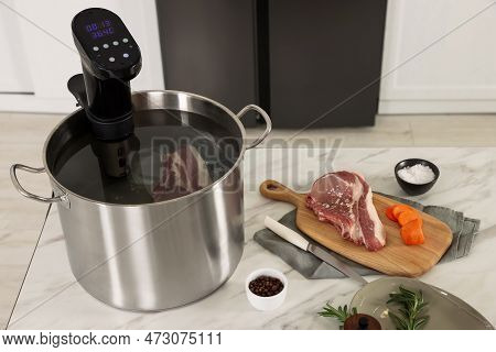 Pot With Sous Vide Cooker And Products On Table Indoors. Thermal Immersion Circulator