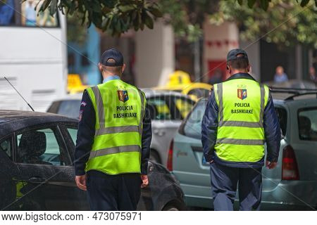 Tirana, Albania - April 23 2019: Two Municipal Policemen (policia Bashkiake) Patrolling The Streets.