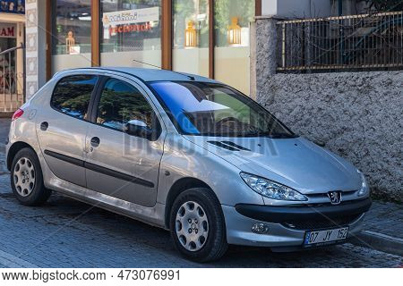 Side, Turkey - February 04  2023:     Silver  Peugeot 207 Is Parked  On The Street On A Warm Summer 