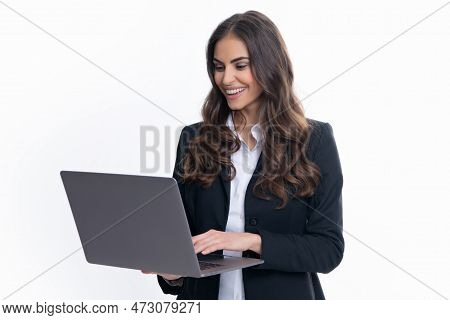 Cheerful Business Woman Standing Over Grey Wall With Laptop Computer. Portrait Of Pretty, Charming, 