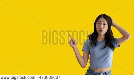 Asian woman pointing finger inviting click here, It is recommended to follow this direction or click