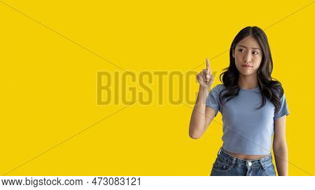 Asian woman pointing finger inviting click here, It is recommended to follow this direction or click