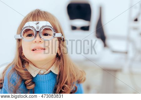 Little Girl Wearing Trial Glasses In Eye Examination Consult Appointment.