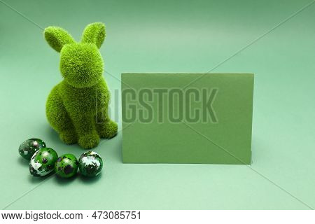 Mockup Easter Green Bunny, Rabbit With Blue Colored Chicken Quail Eggs, Empty Card For Text On Blue 