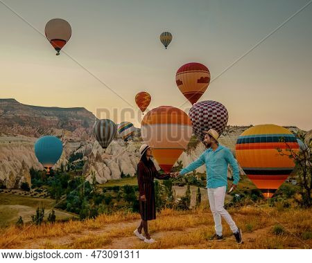Cappadocia Turkey During Sunrise, Couple Mid Age Men And Woman On Vacation In The Hills Of Goreme Ca