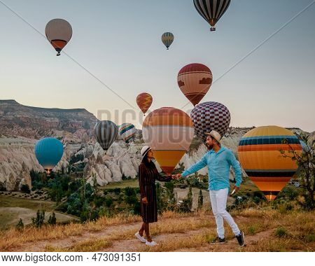 Cappadocia Turkey During Sunrise, Couple Mid Age Men And Woman On Vacation In The Hills Of Goreme Ca