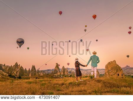 Cappadocia Turkey During Sunrise, Couple Mid Age Men And Woman On Vacation In The Hills Of Goreme Ca