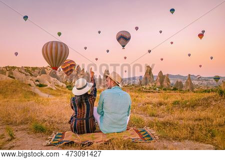 Cappadocia Turkey During Sunrise, Couple Mid Age Men And Woman On Vacation In The Hills Of Goreme Ca
