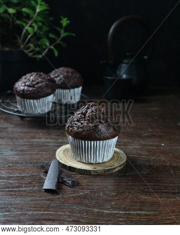 Dark Chocolate Muffin On A Piece Of Wood