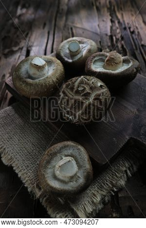 Fresh Shiitake Mushrooms On Wooden Background. Healthy Food.