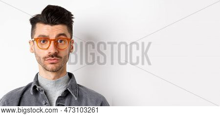 Attractive Brunette Man With Moustache, Wearing Stylish Glasses And Look Serious At Camera, No Emoti