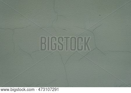 Macro Of Dark Subdued Green Painted Wall With Cracks