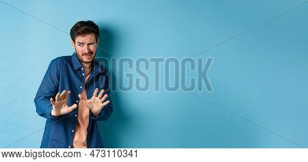 Man Cringe And Stay Away From Something Nasty, Looking Aside And Stretch Out Hands To Reject Bad Dea