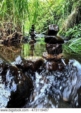 Balanced Zen Rock Stacks In A Creek,view Of A Creek With Stacked Stones On A Rock