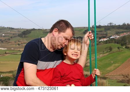 The Tired Father Laid His Head On The Smiling Son. Exhausted Dad And Restless Son