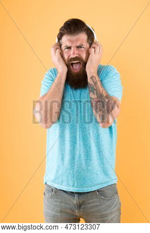 Hipster Listen Broken Headphones Music Gadget. Hateful Song. Music Taste. Bearded Guy Dislike Music.